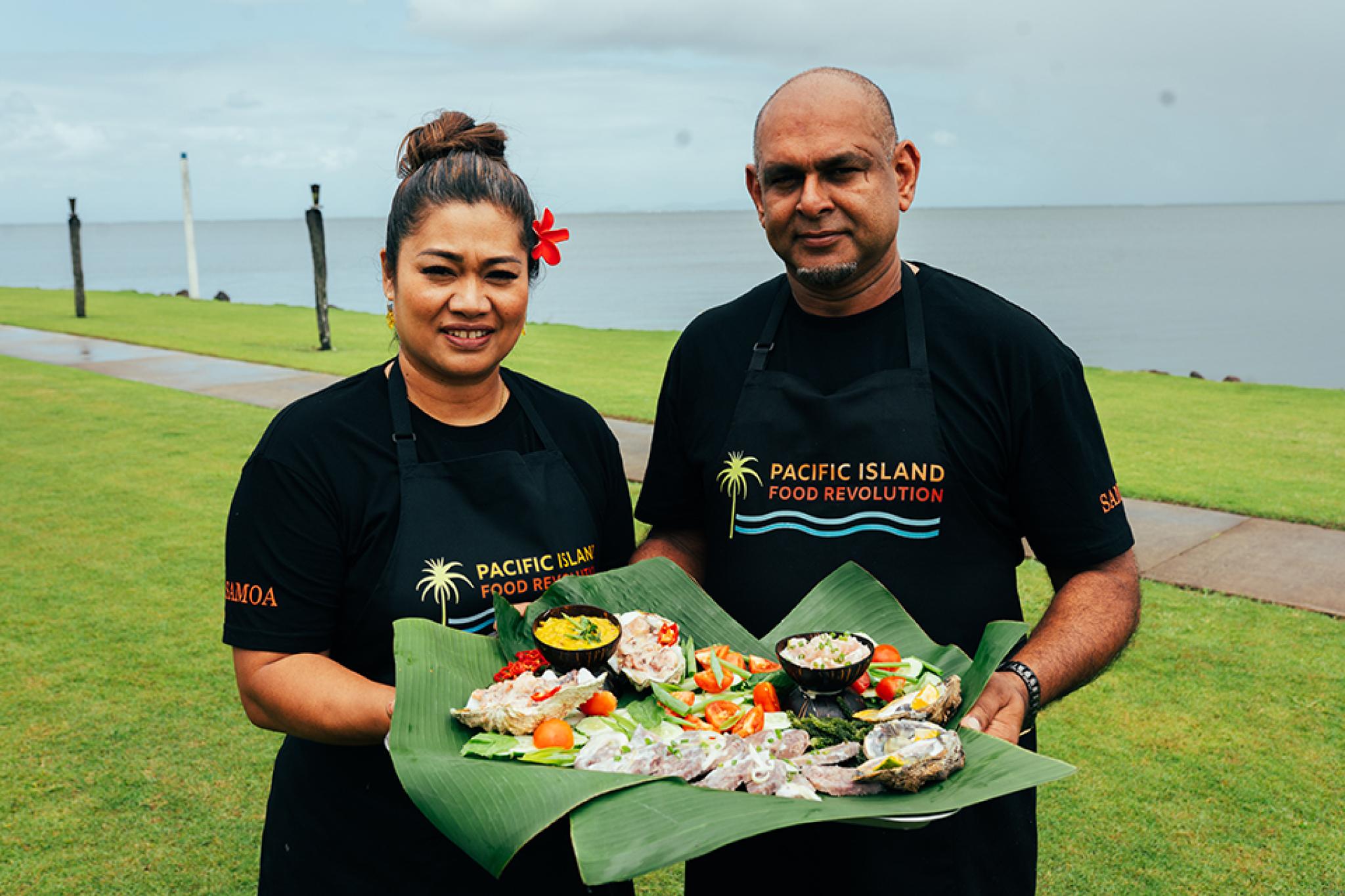 TV hosts holding food image by Pacific Island Food Revolution