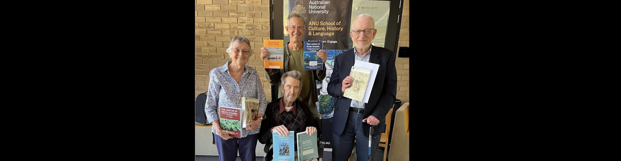Meredith Osmond, Nick Evans, Malcolm Ross and Andrew Pawley holding copies of the volumes