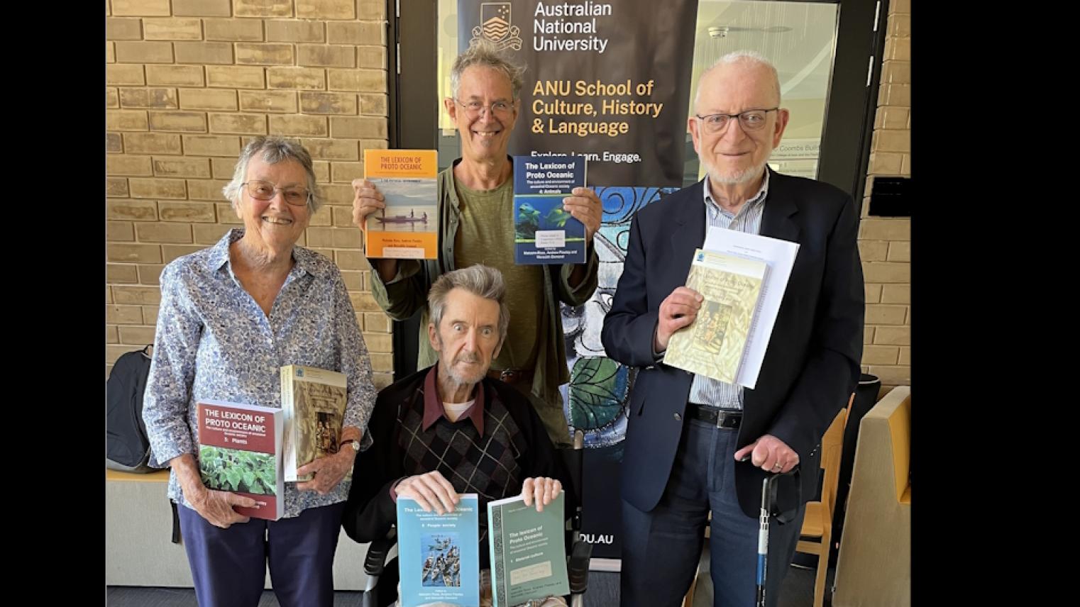 Meredith Osmond, Nick Evans, Malcolm Ross and Andrew Pawley holding copies of the volumes